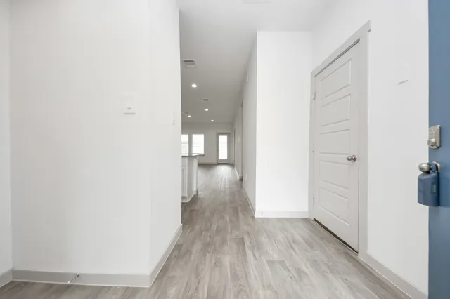 a view of a room with wooden floor