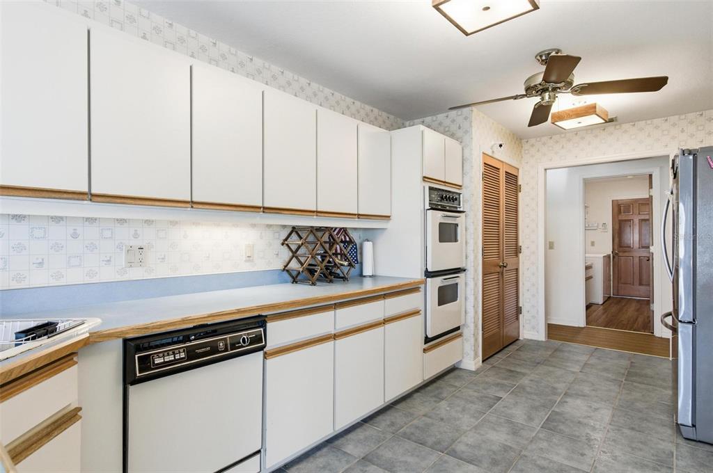 24 Chippeway Court Palm Coast, FL 32137 - Photo 18 of 69 a kitchen with stainless steel appliances white cabinets and a stove top oven
