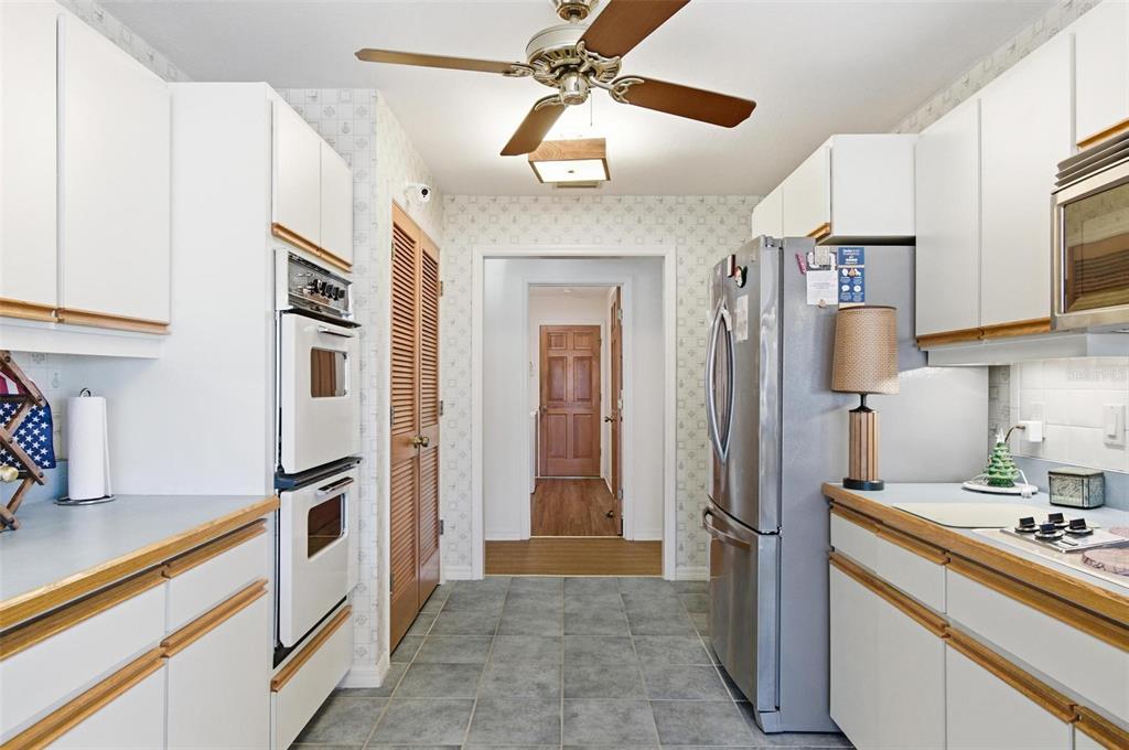 24 Chippeway Court Palm Coast, FL 32137 - Photo 24 of 69 a kitchen with stainless steel appliances granite countertop a refrigerator and a stove top oven