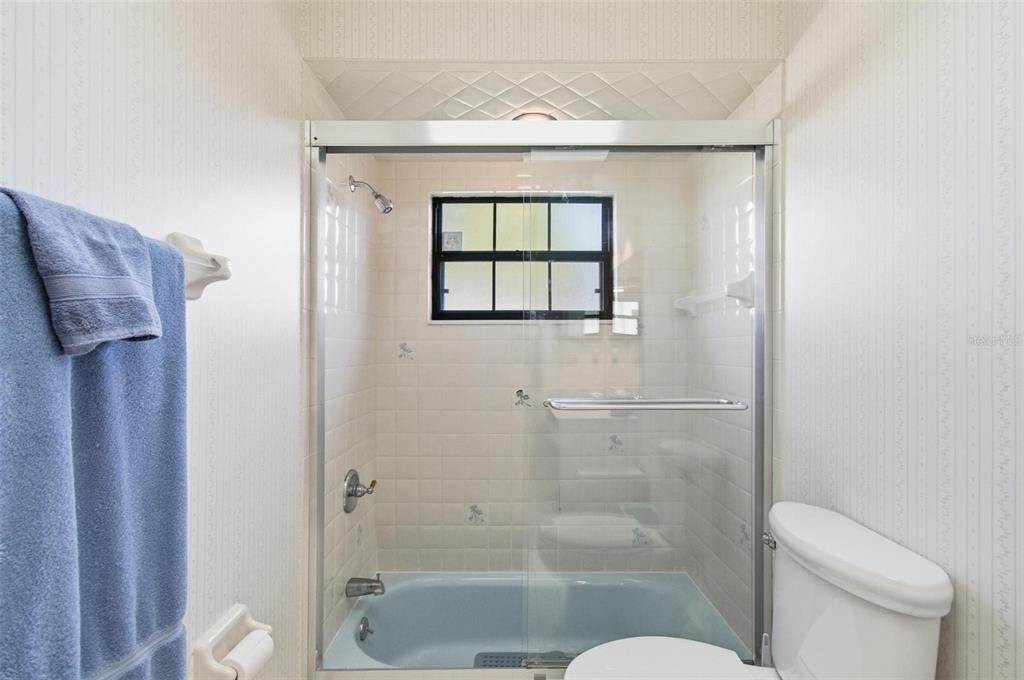 24 Chippeway Court Palm Coast, FL 32137 - Photo 29 of 69 a bathroom with a shower a toilet and a window