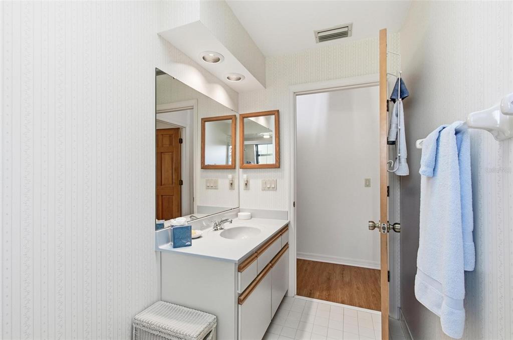 24 Chippeway Court Palm Coast, FL 32137 - Photo 30 of 69 a bathroom with a sink a mirror and a shower