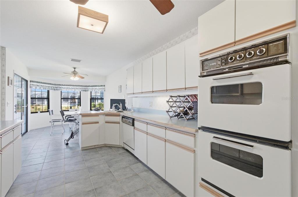 24 Chippeway Court Palm Coast, FL 32137 - Photo 3 of 69 a kitchen with white cabinets and white appliances