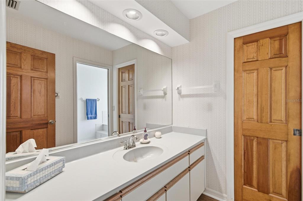 24 Chippeway Court Palm Coast, FL 32137 - Photo 54 of 69 a bathroom with a granite countertop sink and a mirror