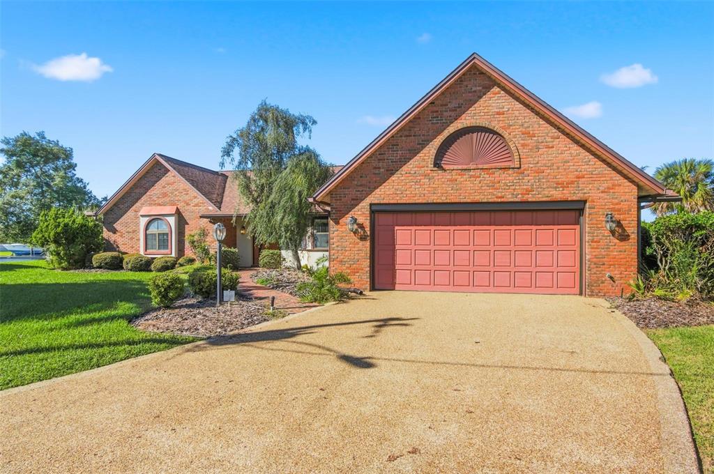 24 Chippeway Court Palm Coast, FL 32137 - Photo 6 of 69 a front view of a house with a yard and garage