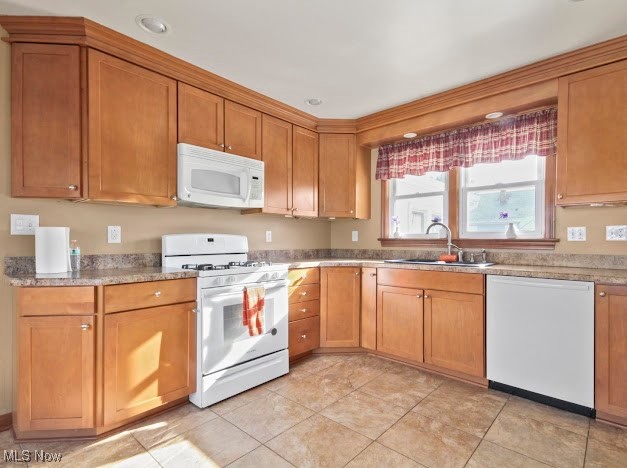 284 Wilson Street Struthers, OH 44471 - Photo 2 of 16 Kitchen featuring white appliances, brown cabinetry, and light countertops