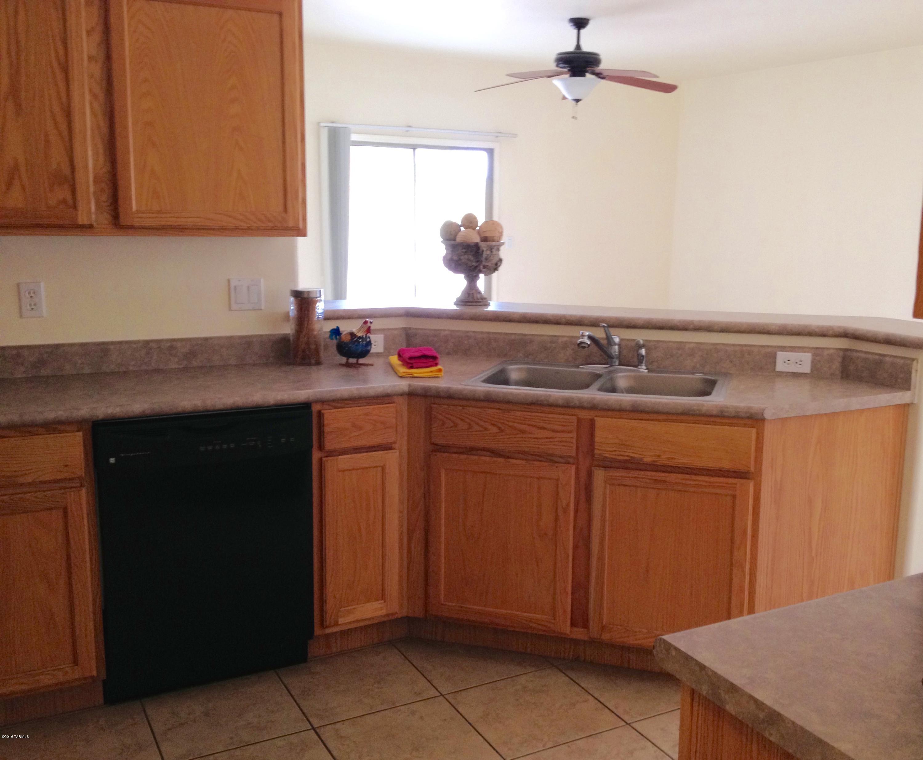 7931 North Iron Ridge Drive Tucson, AZ 85743 - Photo 11 of 21 a kitchen with a sink and cabinets