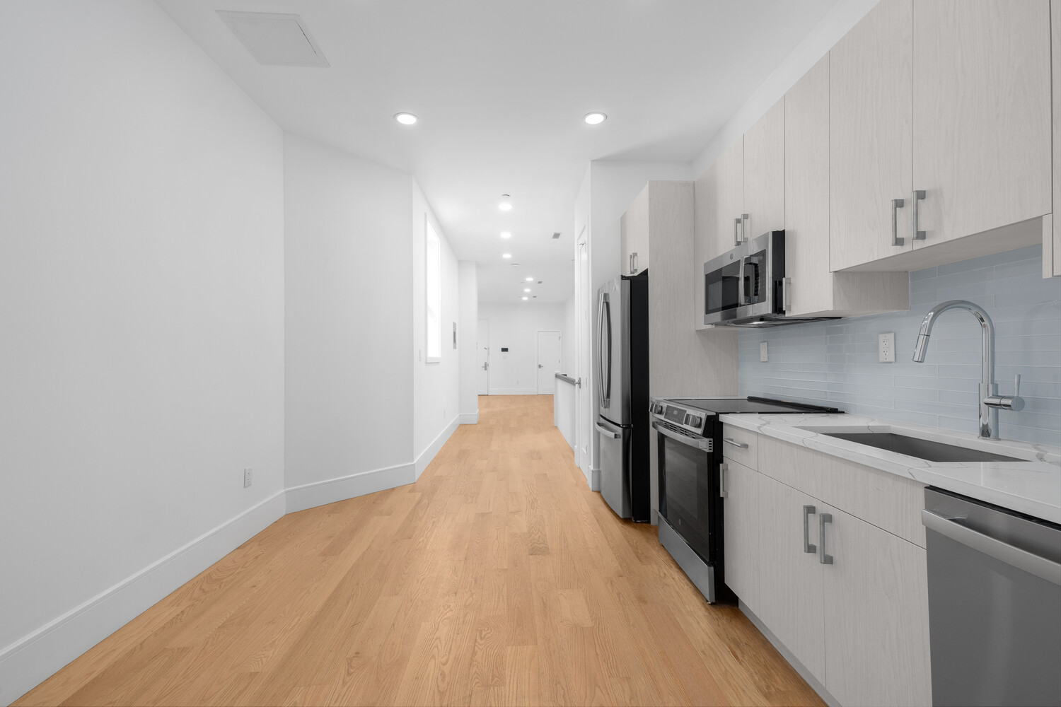 8 West 87th Street, Unit 1B Manhattan, NY 10024 - Photo 4 of 11 a kitchen with stainless steel appliances a refrigerator sink and stove