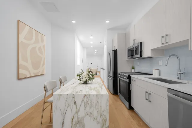 a kitchen with a sink stove and refrigerator