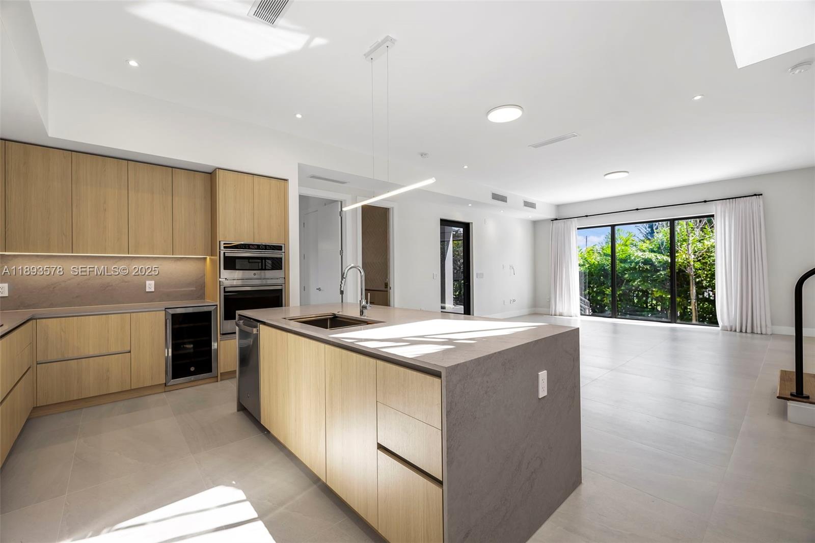 3300 Southwest 27th Terrace, Unit 3300 Miami, FL 33133 - Photo 15 of 76 a kitchen that has a sink and stainless steel appliances