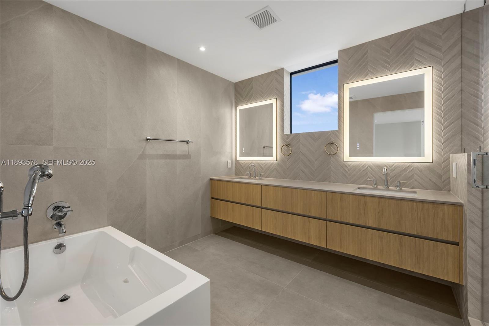 3300 Southwest 27th Terrace, Unit 3300 Miami, FL 33133 - Photo 36 of 76 a bathroom with a tub sink and mirror