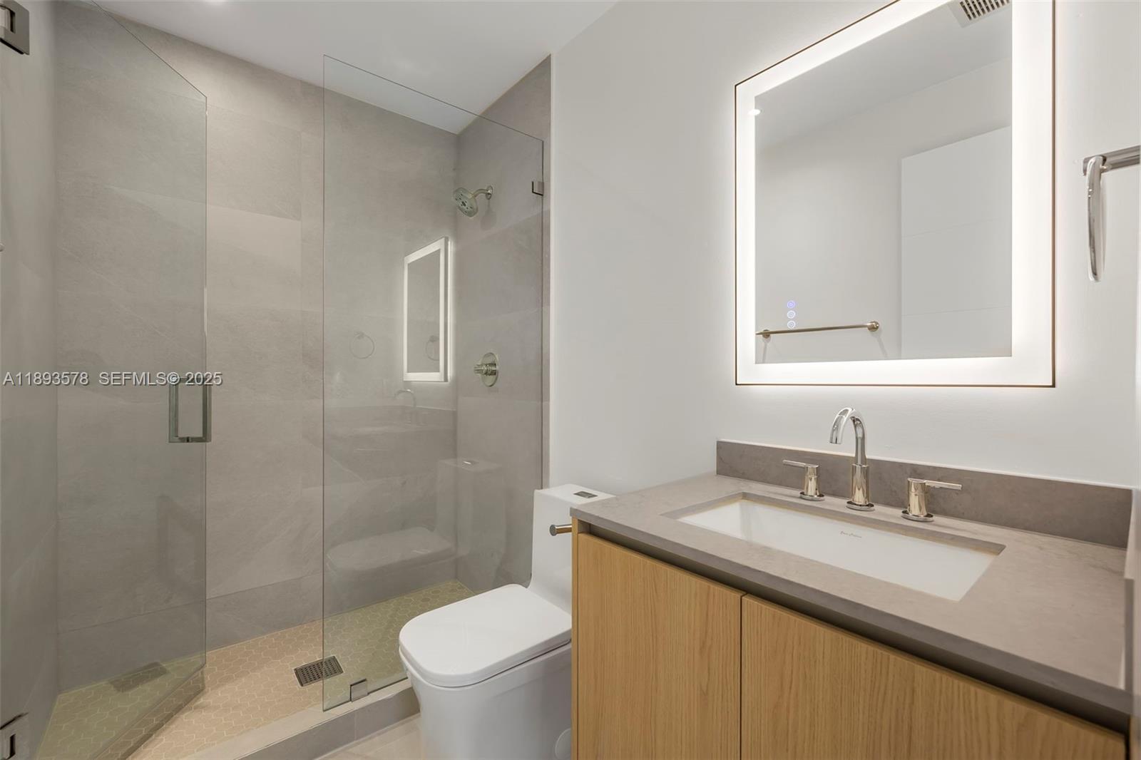 3300 Southwest 27th Terrace, Unit 3300 Miami, FL 33133 - Photo 45 of 76 a bathroom with a granite countertop sink toilet and shower