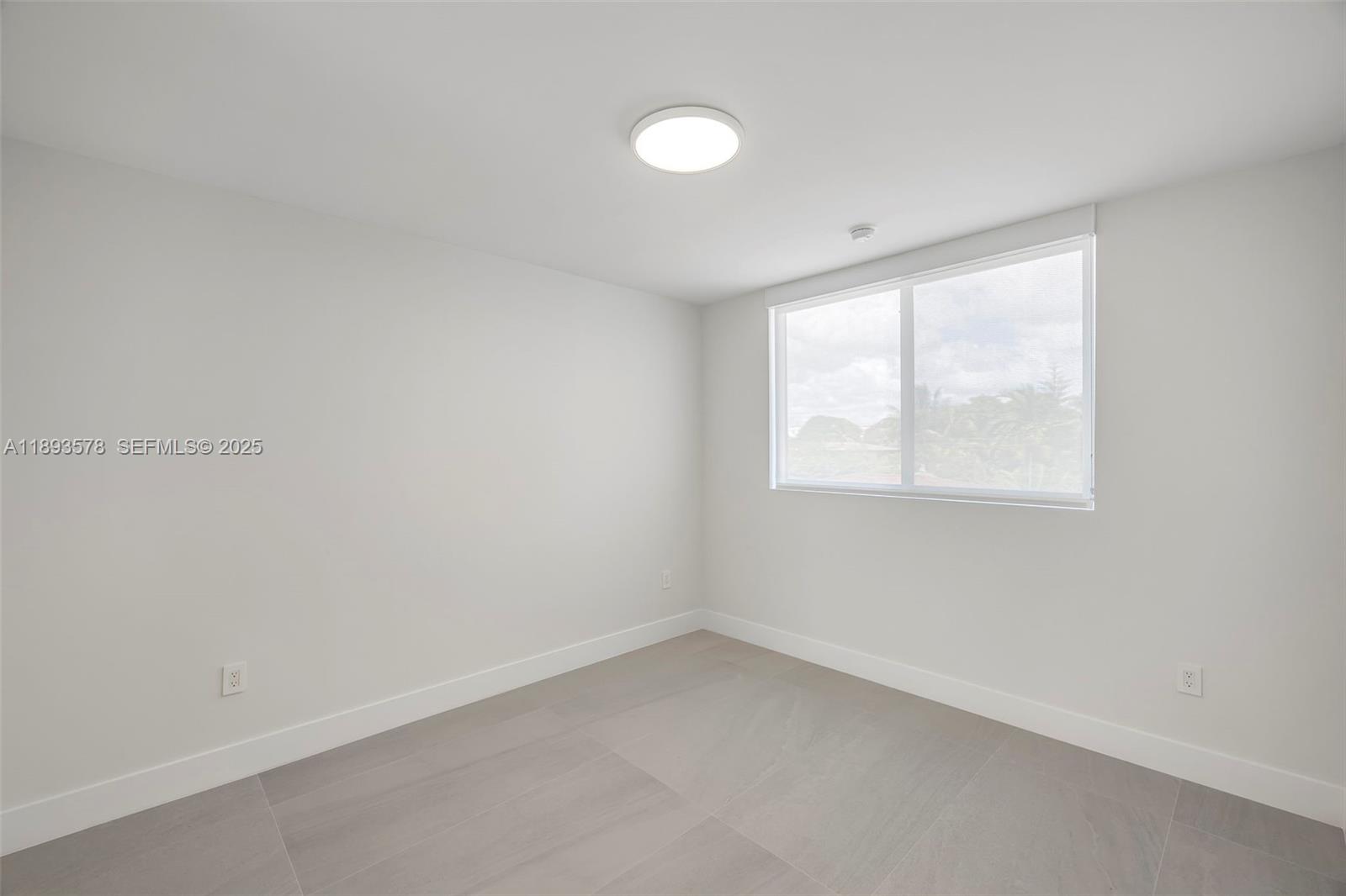 3300 Southwest 27th Terrace, Unit 3300 Miami, FL 33133 - Photo 52 of 76 an empty room with a window