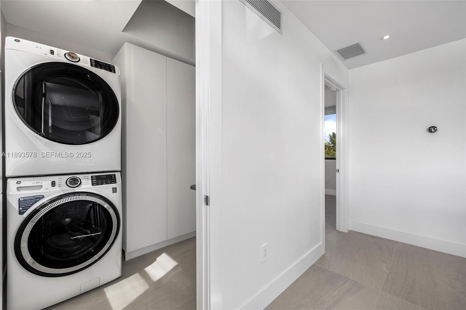 3300 Southwest 27th Terrace, Unit 3300 Miami, FL 33133 - Photo 60 of 76 a view of a hallway with washer and dryer