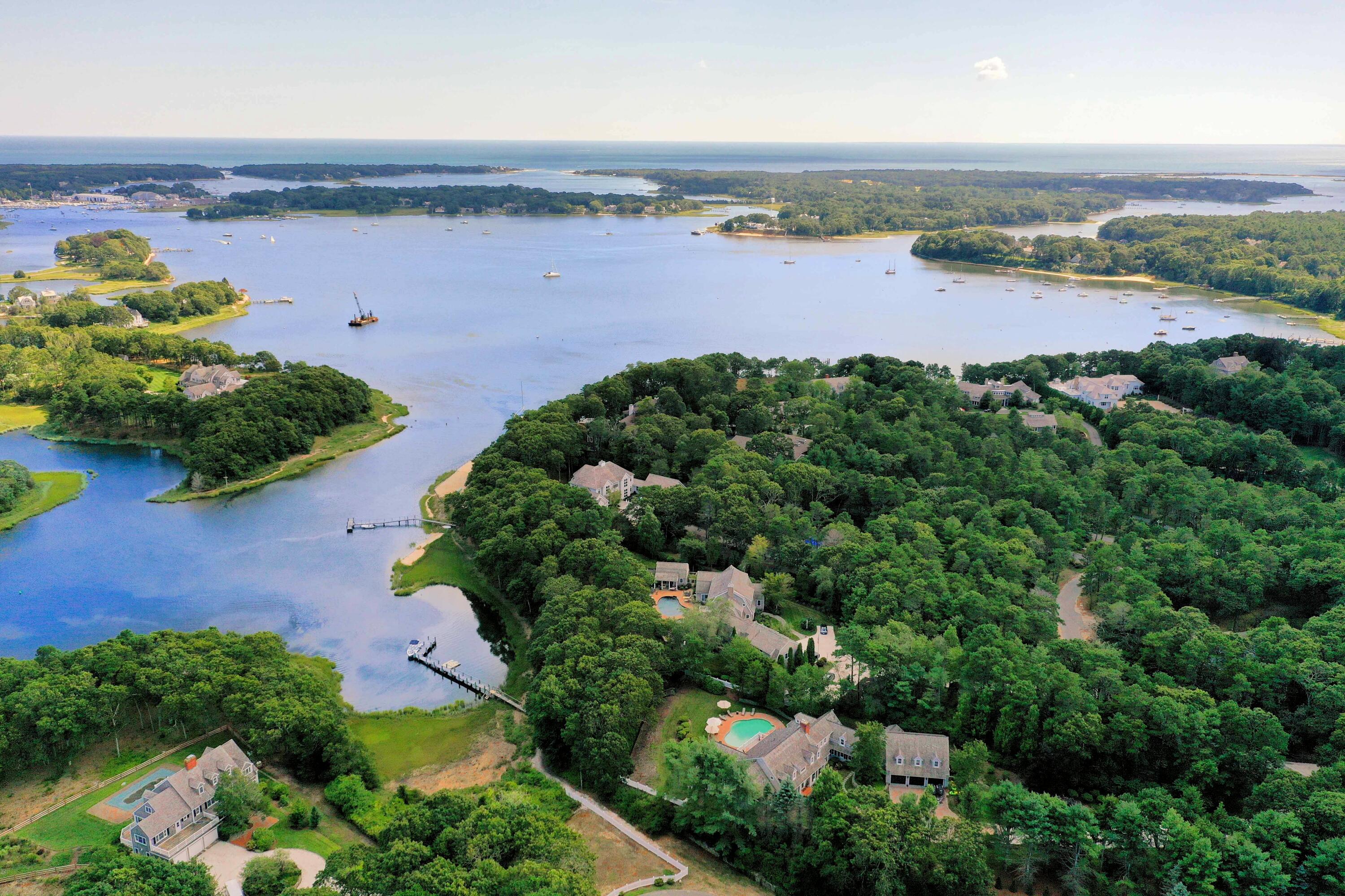 an aerial view of a house with a garden and lake view
