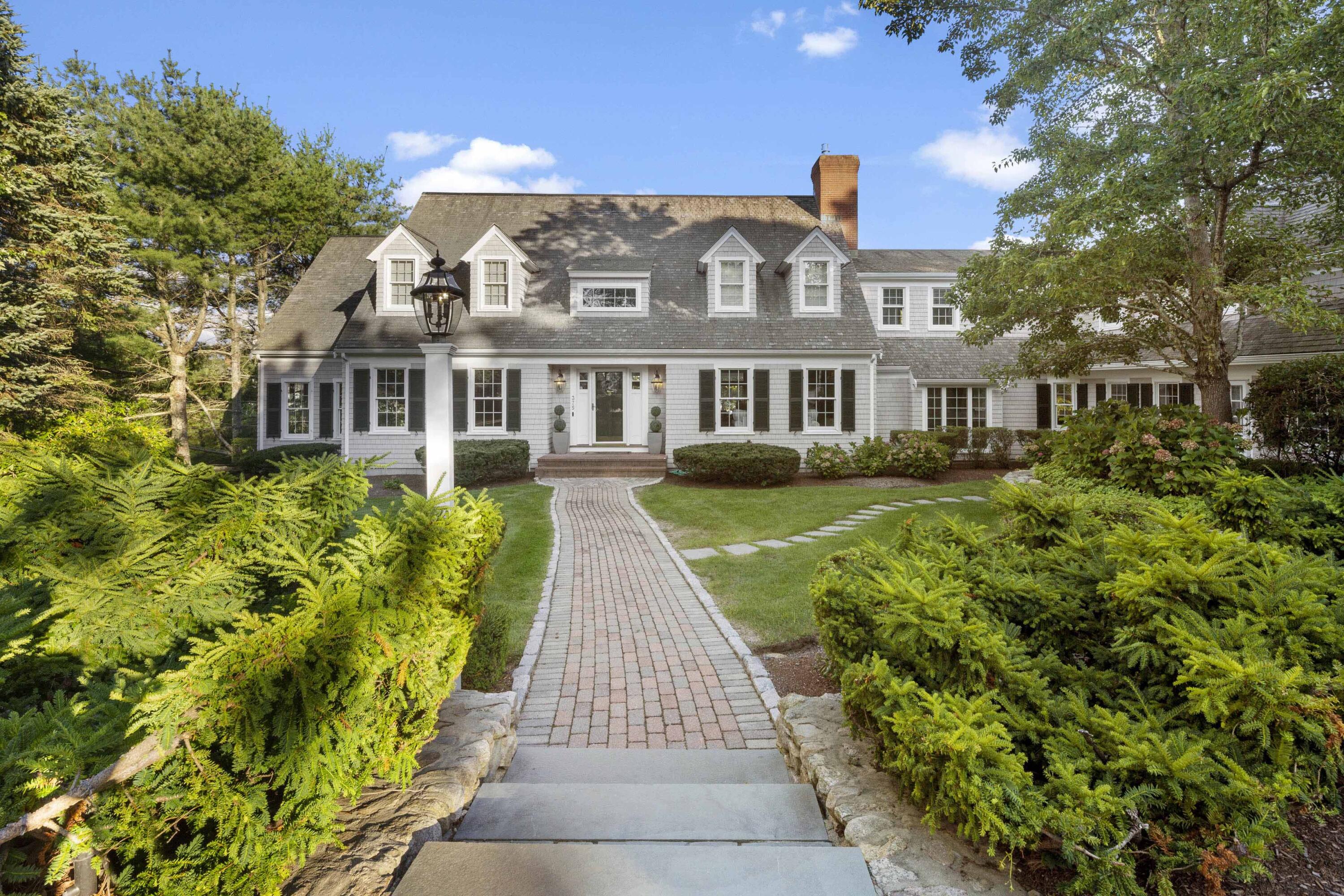 375 Baxter Neck Road Marstons Mills, MA 02648 - Photo 12 of 62 a front view of a house with a garden and plants