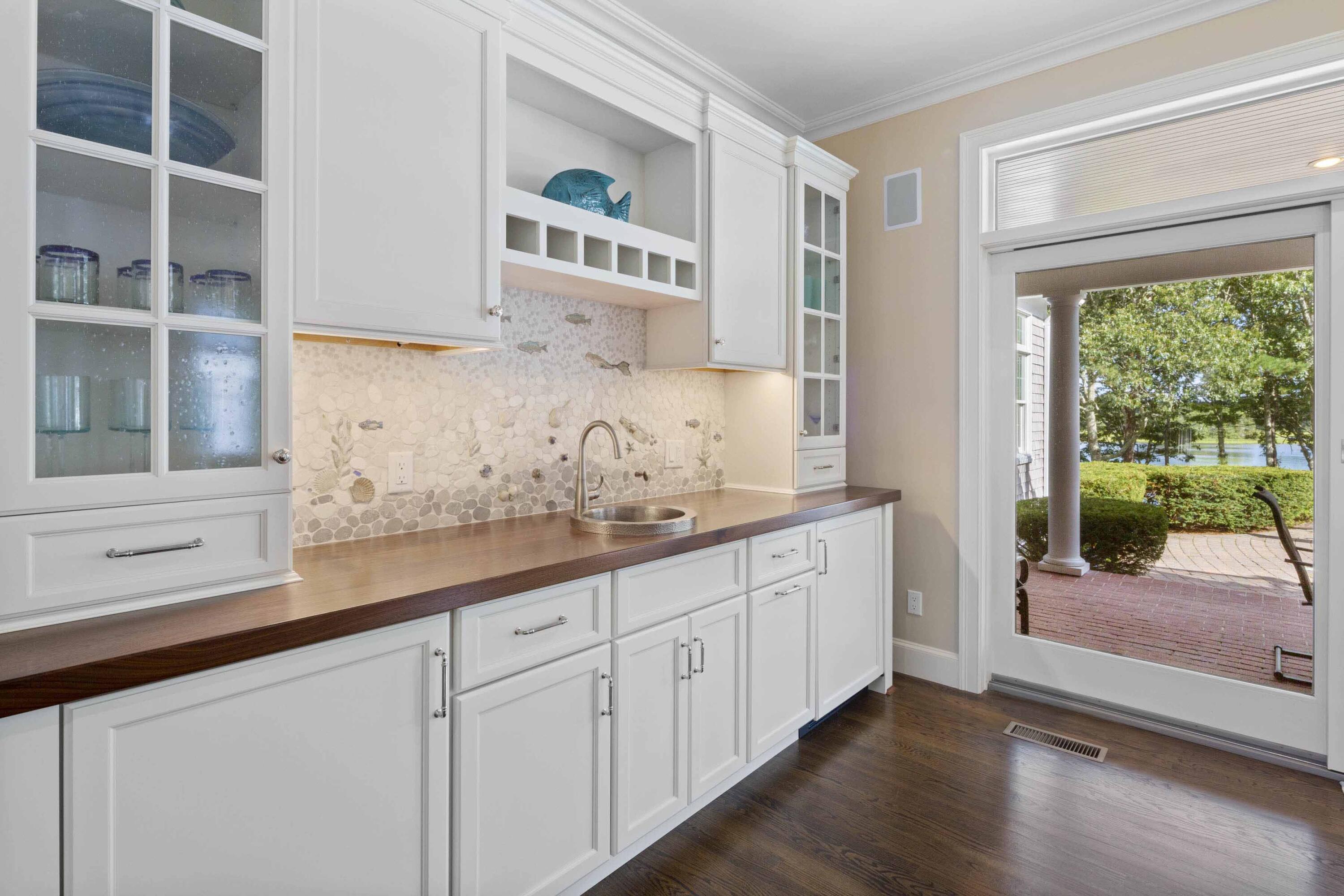 375 Baxter Neck Road Marstons Mills, MA 02648 - Photo 20 of 62 a kitchen with granite countertop white cabinets and a large window