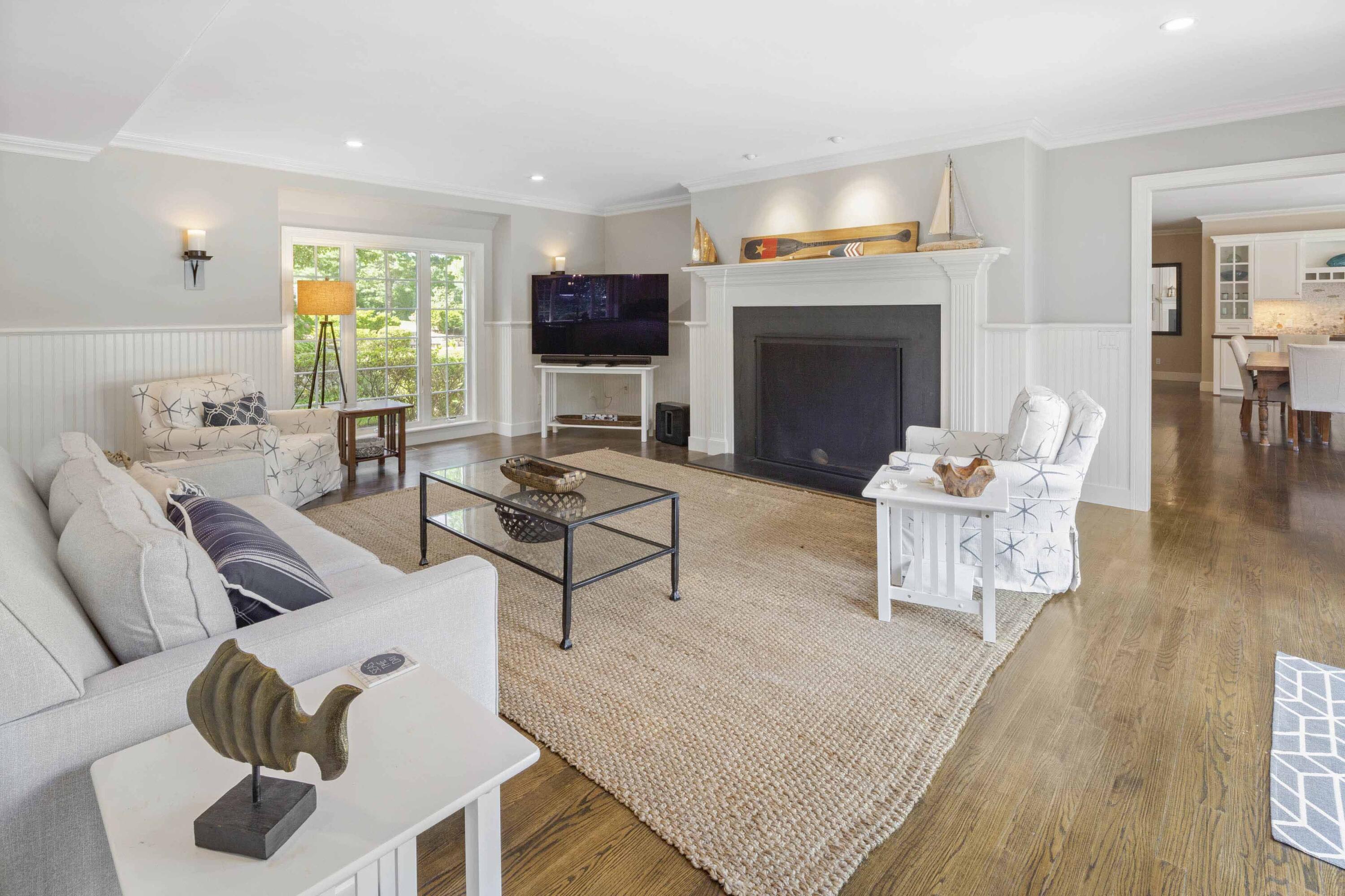 375 Baxter Neck Road Marstons Mills, MA 02648 - Photo 24 of 62 a living room with furniture a fireplace and a flat screen tv