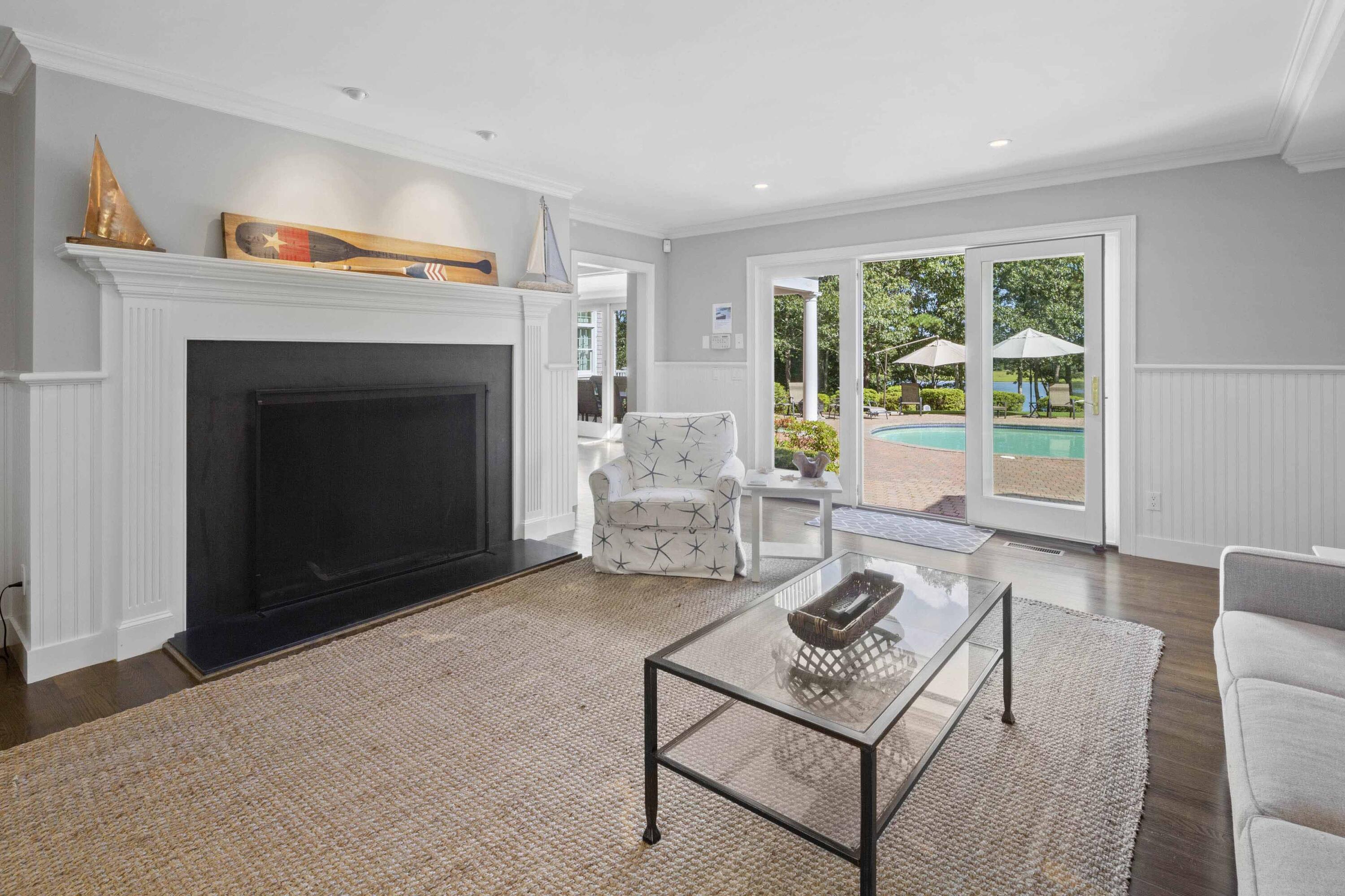 375 Baxter Neck Road Marstons Mills, MA 02648 - Photo 25 of 62 a living room with furniture and a fireplace