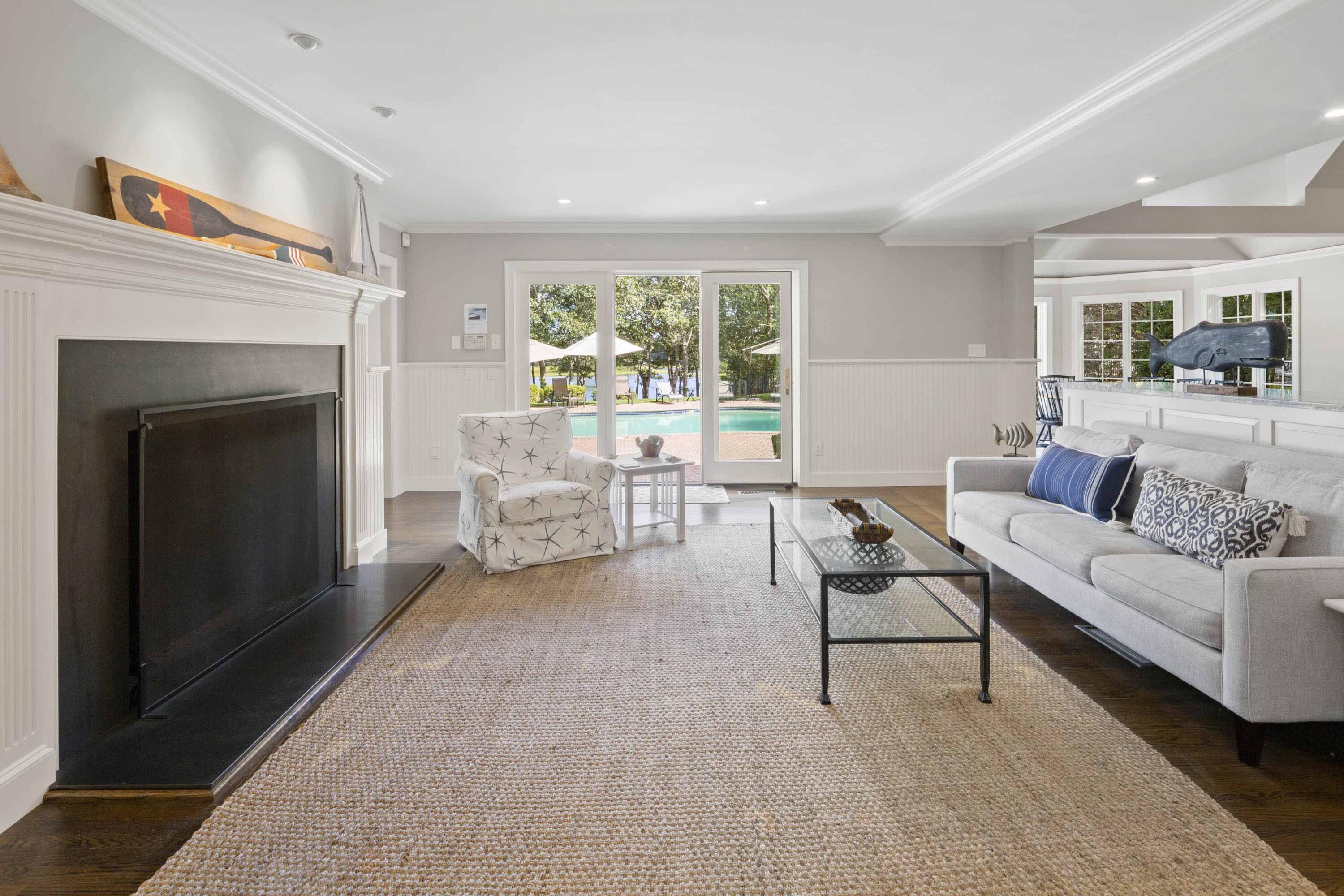 375 Baxter Neck Road Marstons Mills, MA 02648 - Photo 26 of 62 a living room with furniture and a fireplace