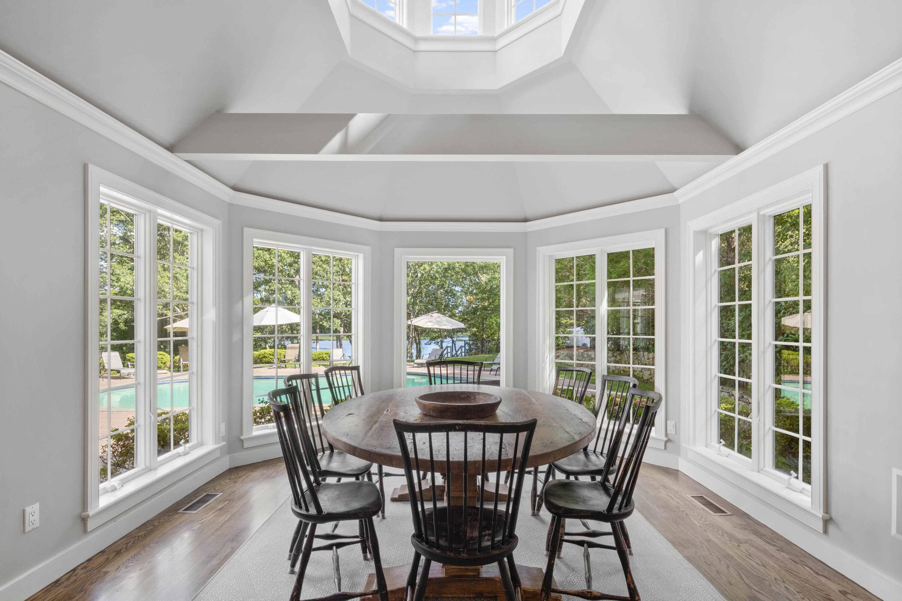 375 Baxter Neck Road Marstons Mills, MA 02648 - Photo 31 of 62 a view of a dining room with furniture large windows and wooden floor