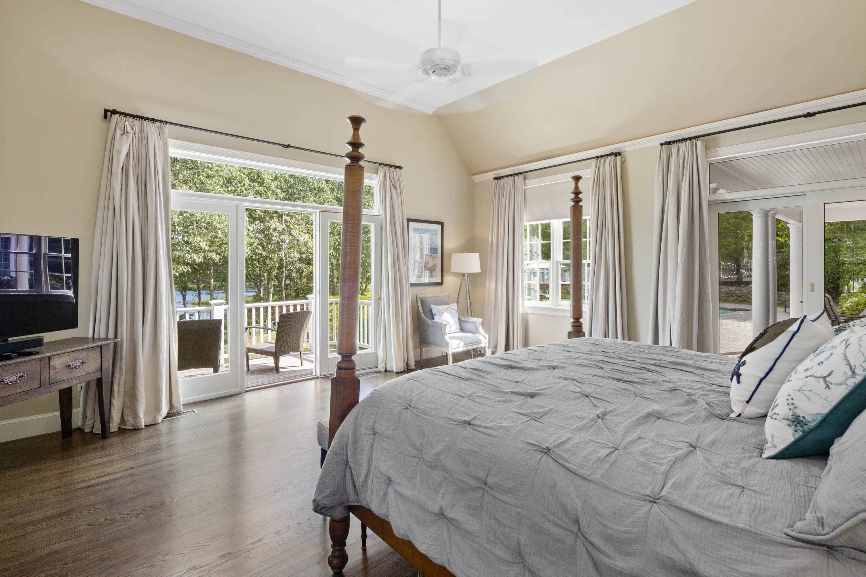 375 Baxter Neck Road Marstons Mills, MA 02648 - Photo 33 of 62 a bedroom with a balcony a bed and a flat screen tv