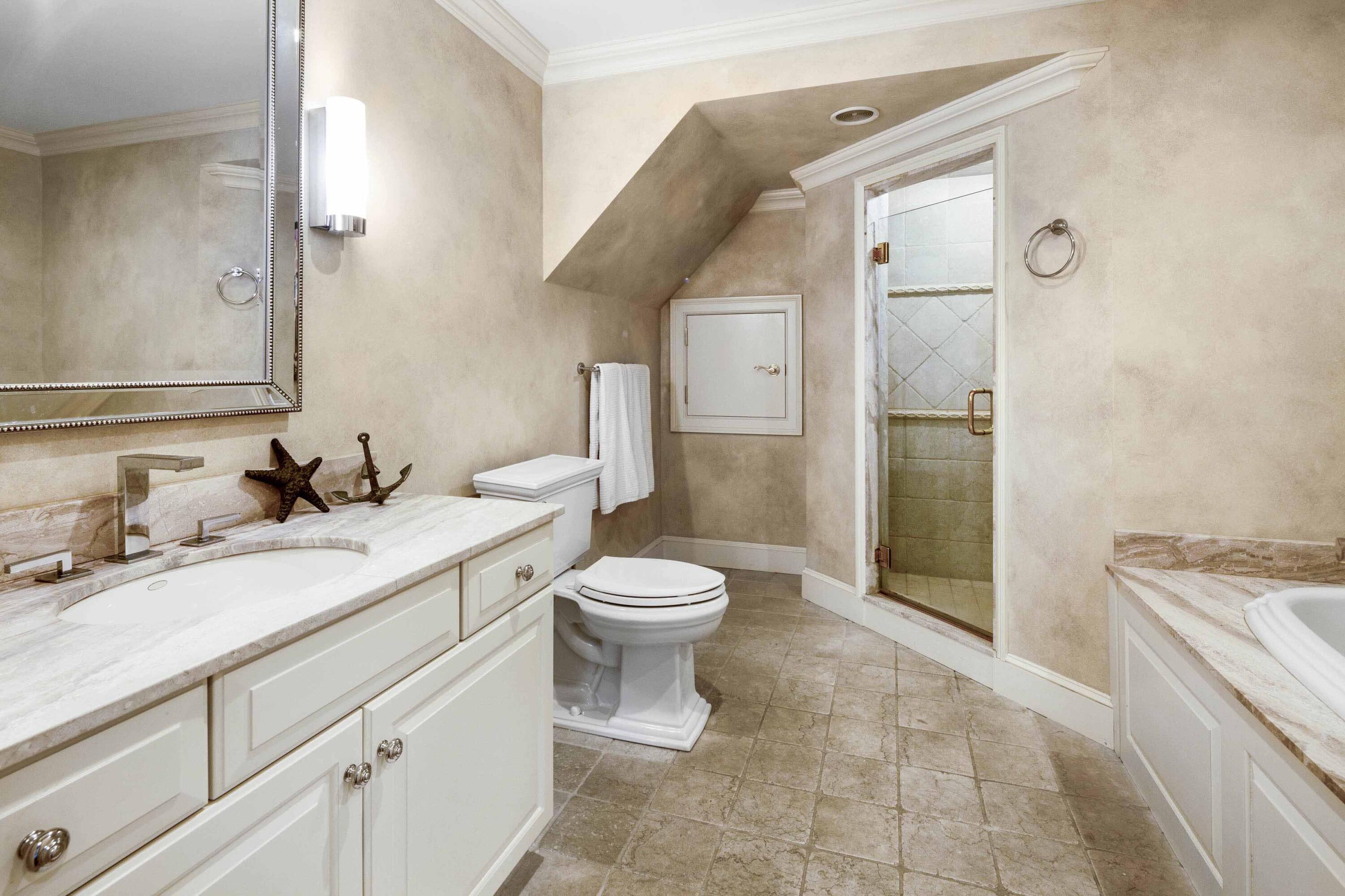 375 Baxter Neck Road Marstons Mills, MA 02648 - Photo 46 of 62 a bathroom with a granite countertop toilet a sink a mirror and a shower