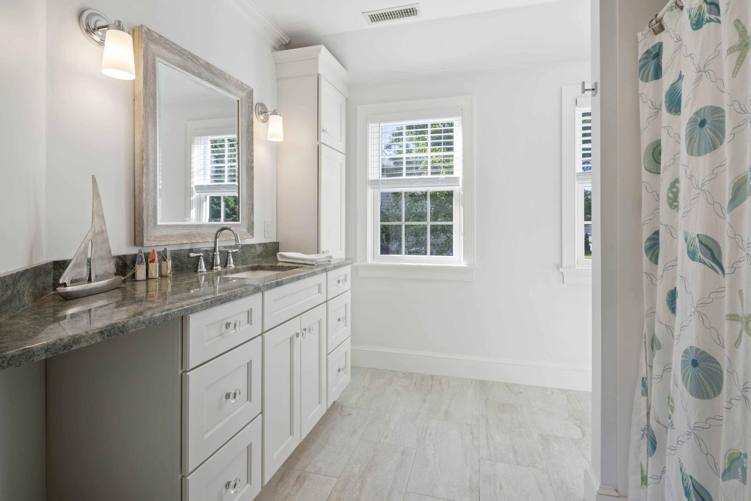 375 Baxter Neck Road Marstons Mills, MA 02648 - Photo 50 of 62 a bathroom with a granite countertop sink two mirror and a shower