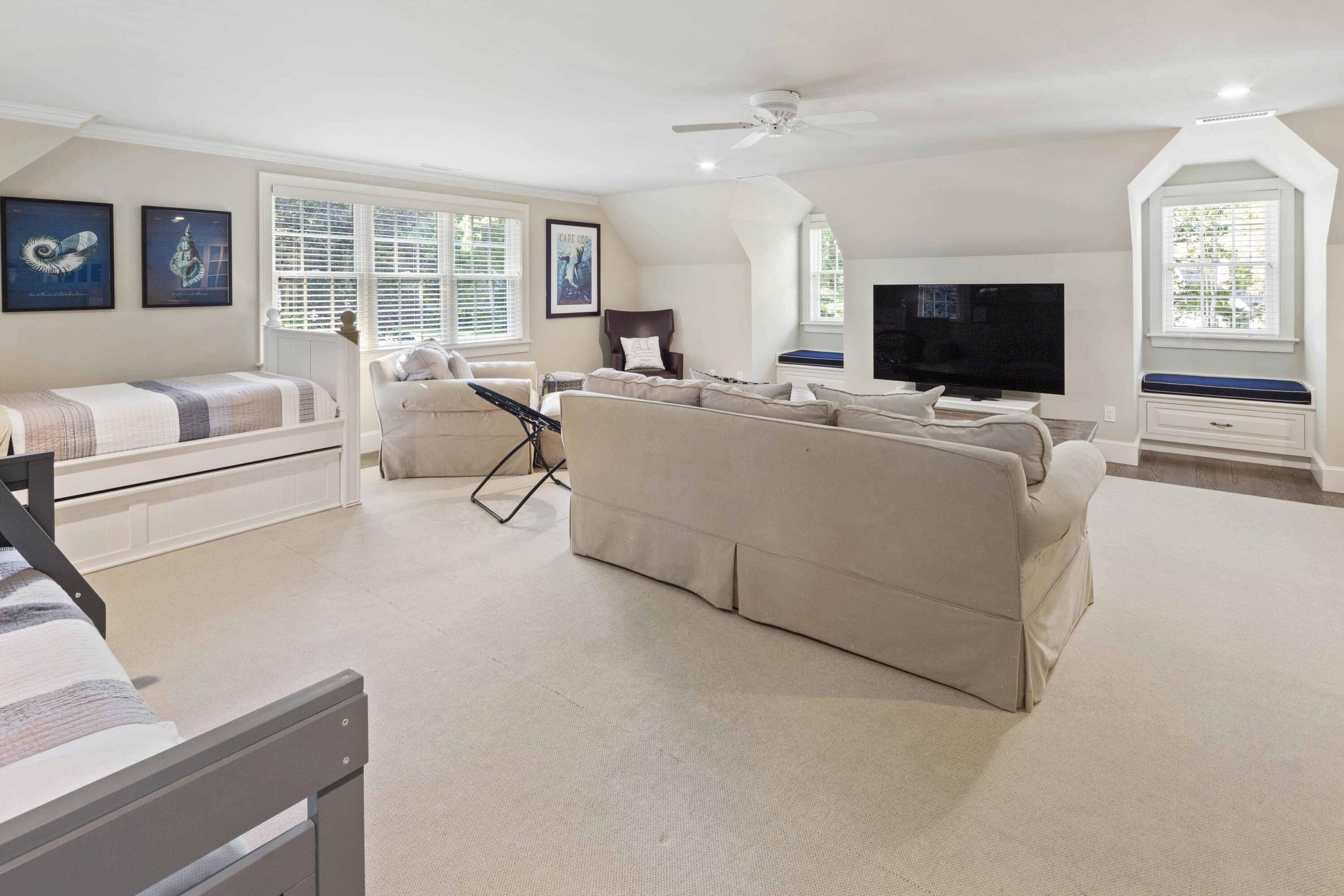 375 Baxter Neck Road Marstons Mills, MA 02648 - Photo 53 of 62 a living room with furniture a flat screen tv and a large window