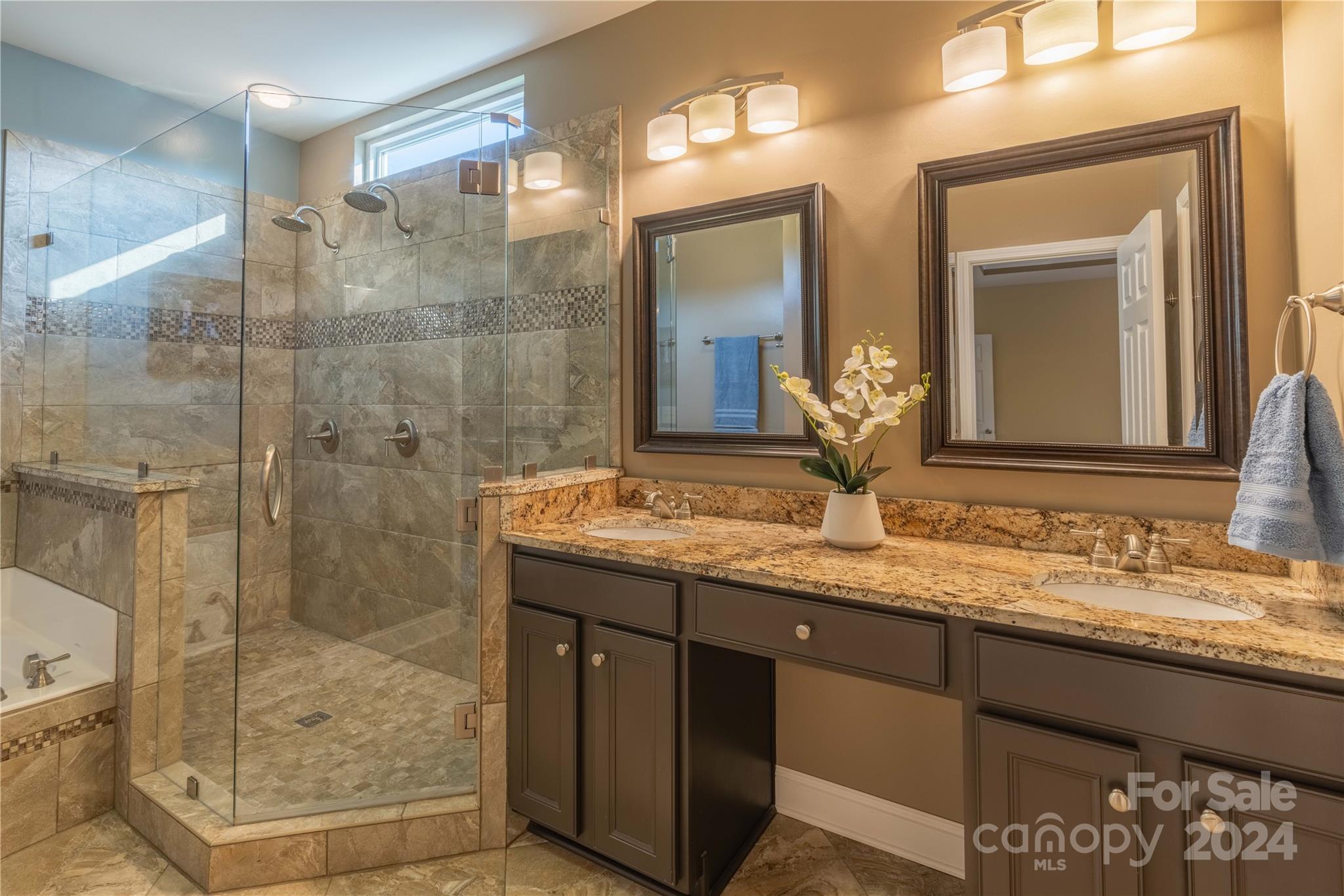 3359 Merchant Lane Davidson, NC 28036 - Photo 17 of 48 a bathroom with a granite countertop sink a mirror and shower
