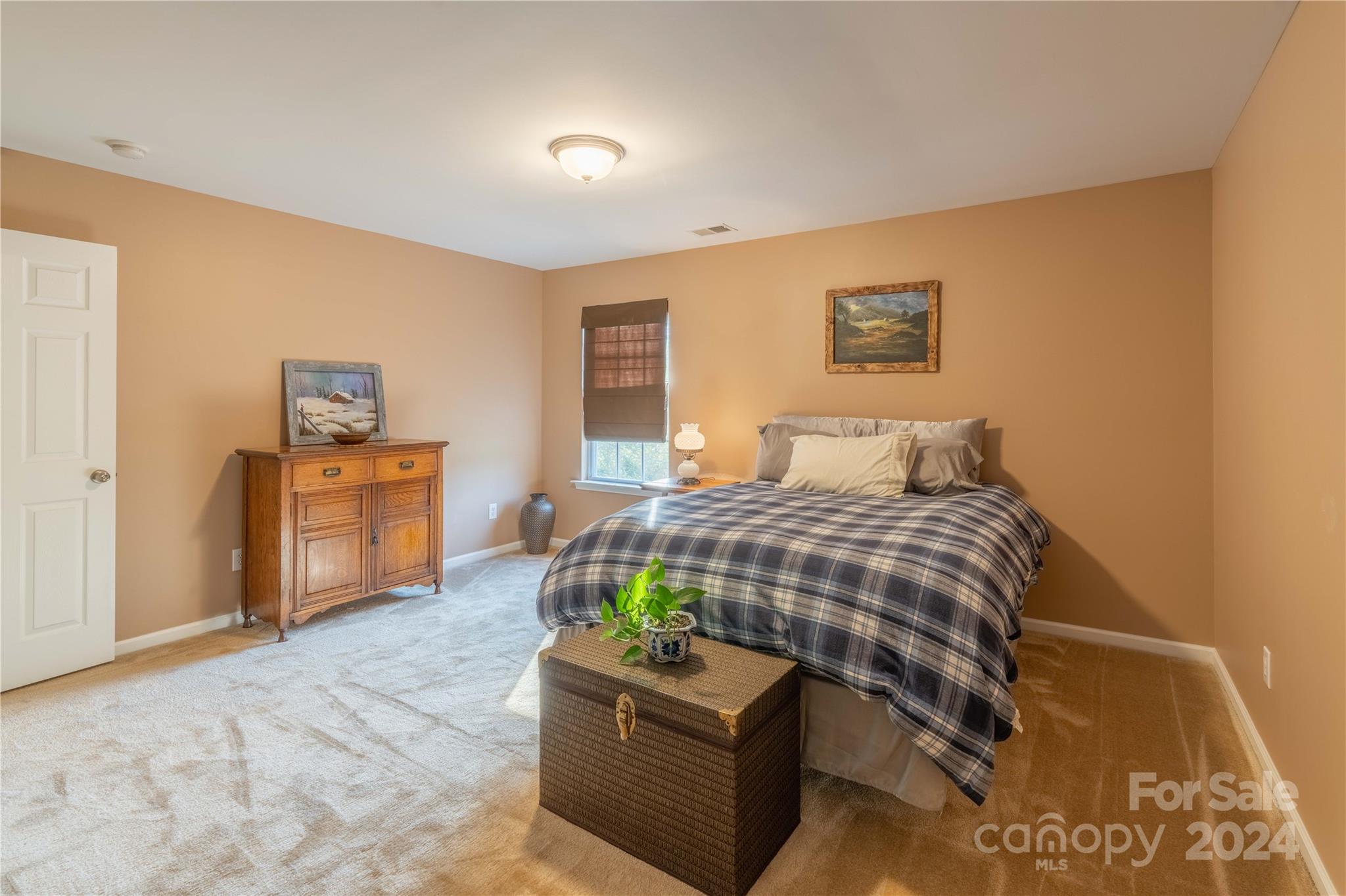 3359 Merchant Lane Davidson, NC 28036 - Photo 25 of 48 a bedroom with a bed and wooden floor