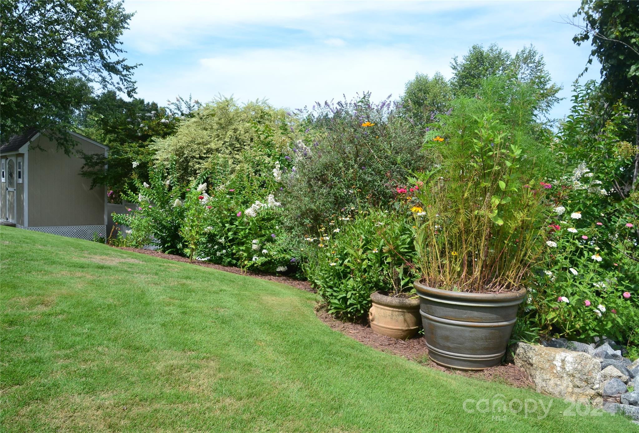 3359 Merchant Lane Davidson, NC 28036 - Photo 35 of 48 a view of a backyard with table and chairs potted plants