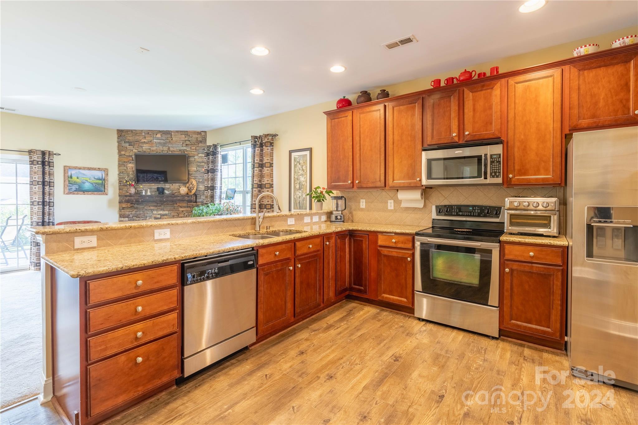 3359 Merchant Lane Davidson, NC 28036 - Photo 6 of 48 a kitchen with stainless steel appliances a stove sink and microwave