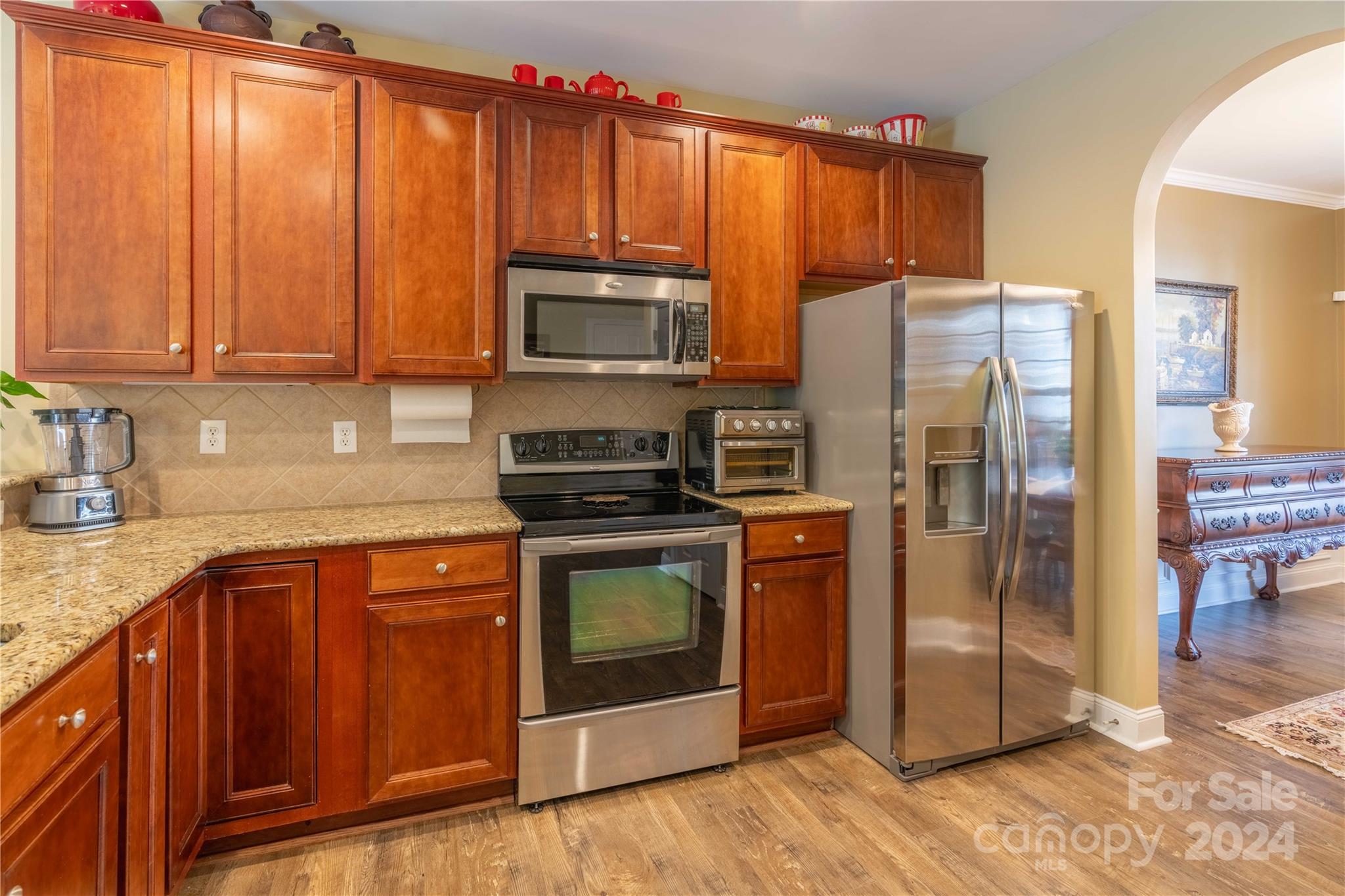 3359 Merchant Lane Davidson, NC 28036 - Photo 7 of 48 a kitchen with stainless steel appliances granite countertop a refrigerator stove top oven a sink and dishwasher