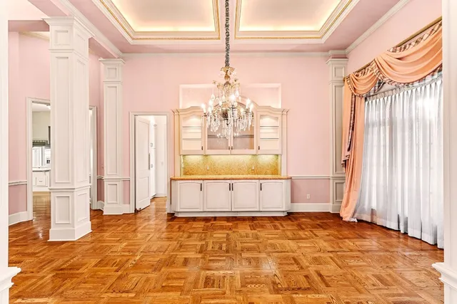 a large hall with wooden floor and windows