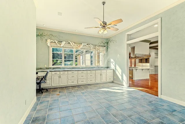 a kitchen with granite countertop a refrigerator and a stove top oven