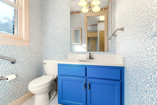 a bathroom with a sink a toilet and a mirror