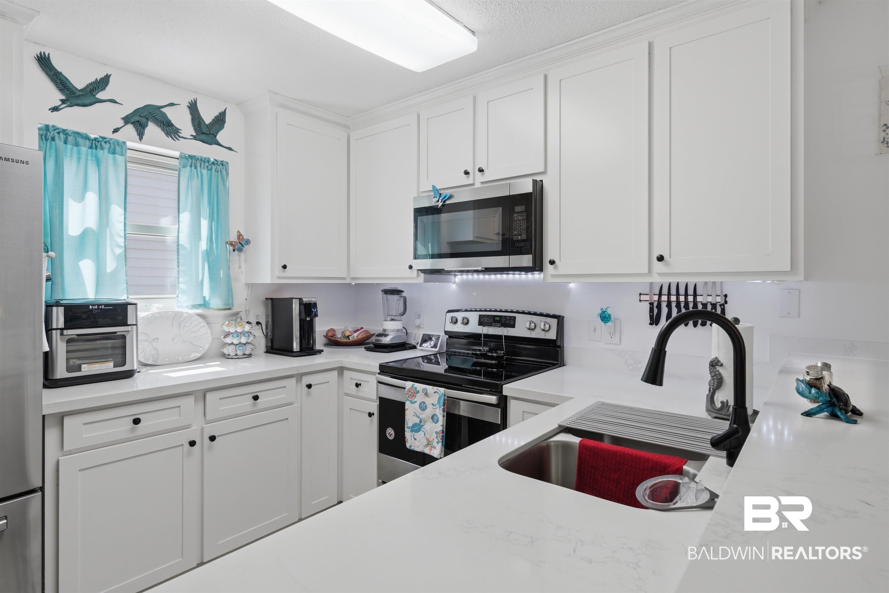 389 Clubhouse Drive, Unit 5H Gulf Shores, AL 36542 - Photo 8 of 43 SS appliances, quartz counter tops, and new window.