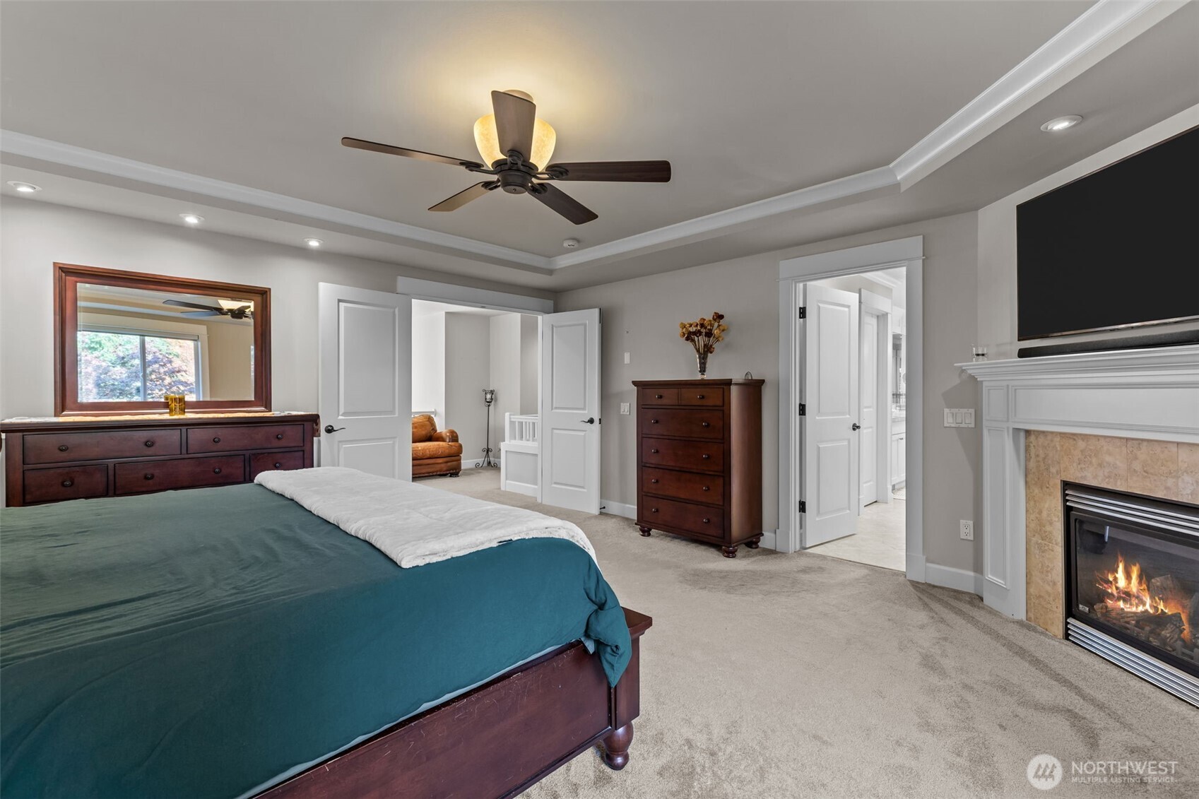 8614 Northeast 198th Street Bothell, WA 98011 - Photo 17 of 40 a spacious bedroom with a bed and a flat screen tv