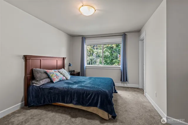a living room with furniture and dresser