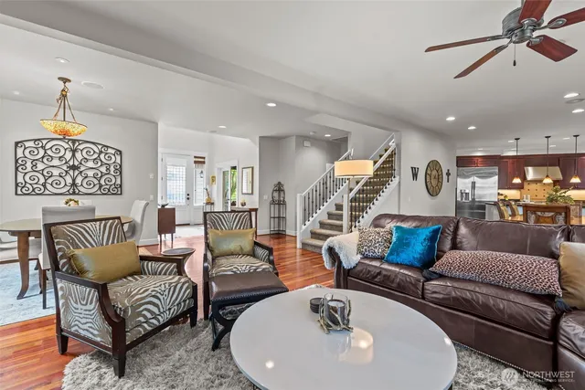 a living room with furniture kitchen view and a chandelier