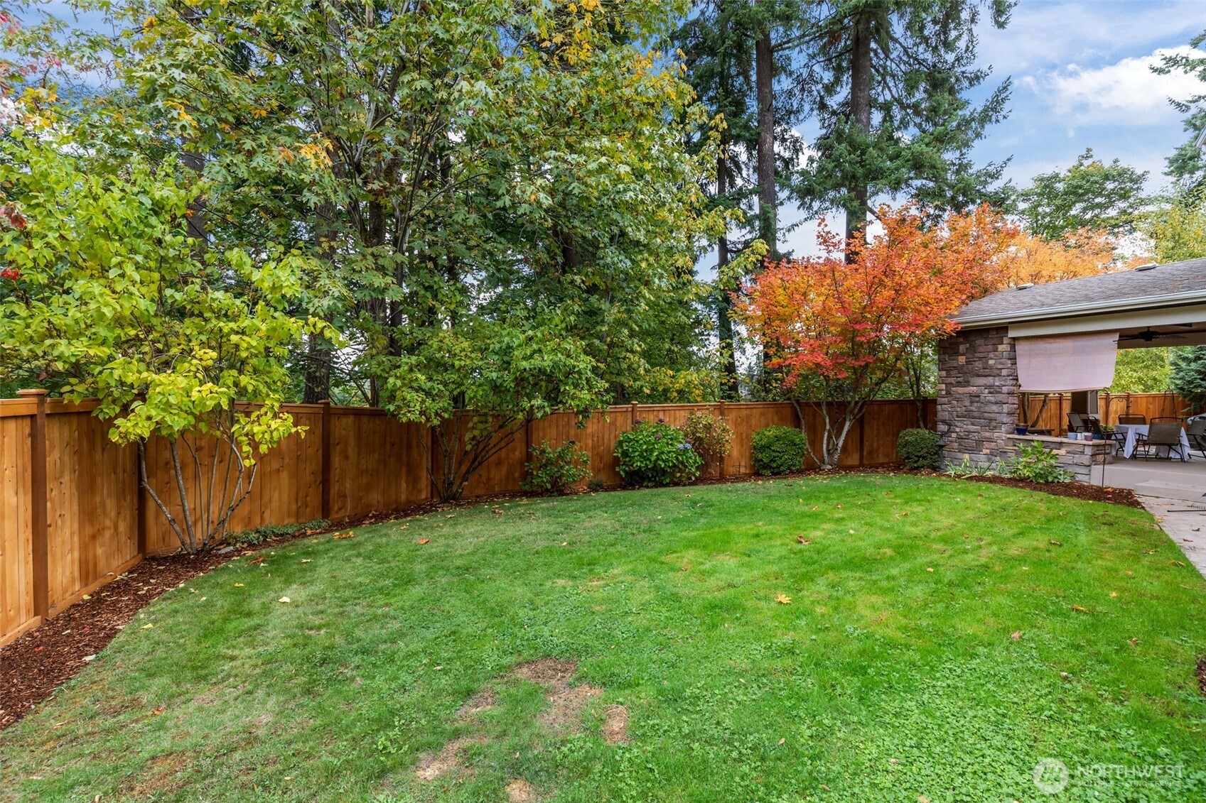 8614 Northeast 198th Street Bothell, WA 98011 - Photo 32 of 40 a view of a backyard with table and chairs and a tree
