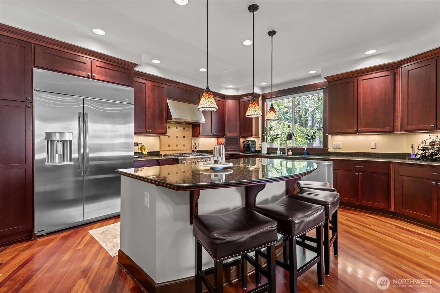 8614 Northeast 198th Street Bothell, WA 98011 - Photo 6 of 40 a kitchen with stainless steel appliances granite countertop wooden floor window and cabinets