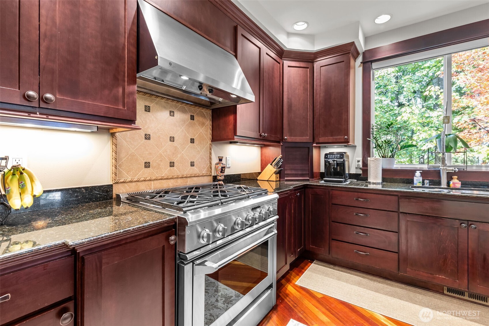 8614 Northeast 198th Street Bothell, WA 98011 - Photo 10 of 40 a kitchen with granite countertop a sink stove and cabinets