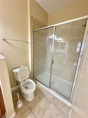 a bathroom with a toilet and a shower