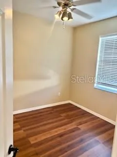 a view of a room with wooden floor and fan