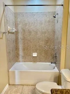 a bathroom with a bathtub and shower