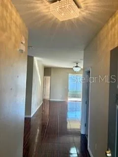 a view of a hallway view with wooden floor and staircase