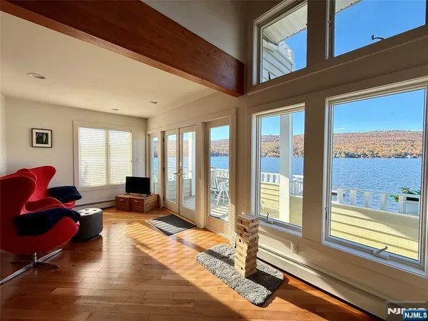 a living room with furniture and large windows