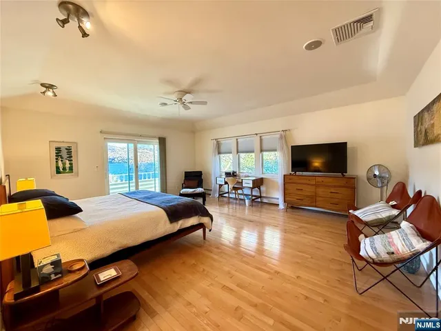 a bedroom with furniture and a flat screen tv