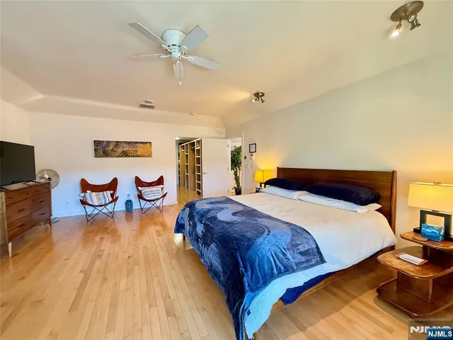 a bedroom with bed and table